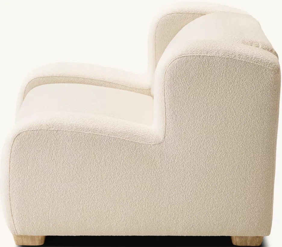 Fauteuil lounge Grasse en tissu bouclé et bois massif, vue 3 sur 5